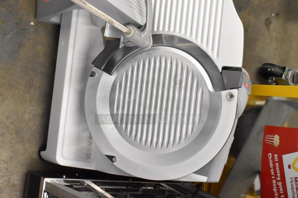 BRAND NEW Berkel X13-PLUS meat slicer, metal, automatic, with blade sharpener. 120V, 1-phase. Minor scratches and dents visible.