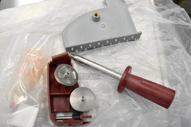 Berkel X13-PLUS automatic meat slicer parts and blade sharpener; metal construction, red handle, new condition.