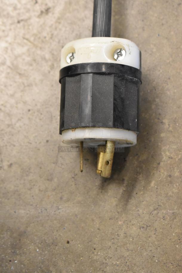 Close-up of the plug for an Ojeda RDCH-3 Deli Display Case, showing prongs and black housing, indicating electrical details.