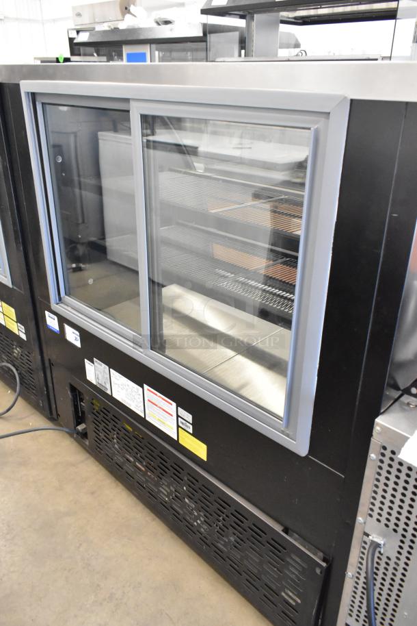 Ojeda RDCH-4 metal commercial deli display case, 120V, 1 Phase, with glass doors and shelving, in excellent condition.