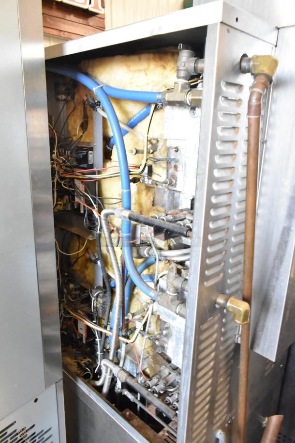 Market Forge ETP-10G stainless steel steam cabinet internals, showing wiring and hoses. Features commercial casters.