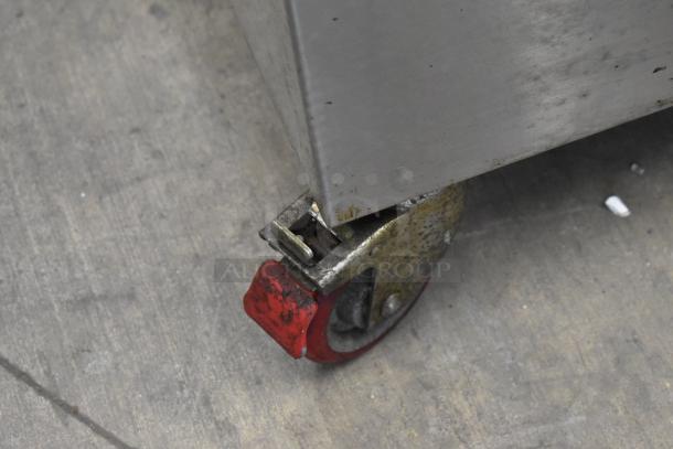 VacMaster VP545 stainless steel vacuum sealer on red commercial caster, showing wear. 110 volts, 1 phase.