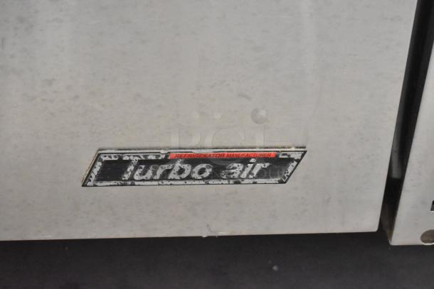 Turbo Air stainless steel 4-drawer chef base on casters, 115V, 1 phase, visible logo, worn finish.