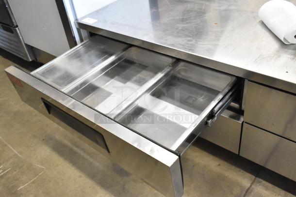 Turbo Air stainless steel commercial 4-drawer chef base on casters, showing open drawers. 115 volts, 1 phase.