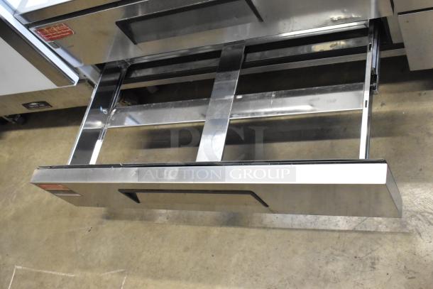 Turbo Air stainless steel 4-drawer chef base on commercial casters, 115 volts, 1 phase, open drawer view, clean condition.
