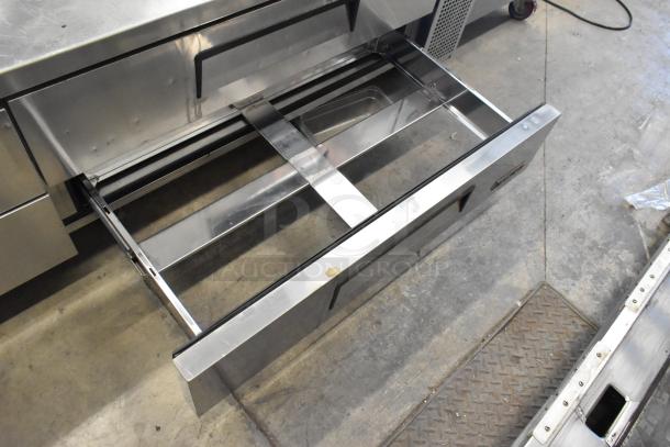 Turbo Air stainless steel commercial chef base with 4 drawers on casters, 115 volts, showing open drawer detail.