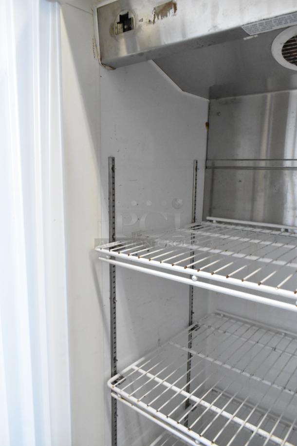 Arctic Air metal commercial single door reach-in freezer interior with wire shelves. 115 volts, 1 phase. Commercial casters included.
