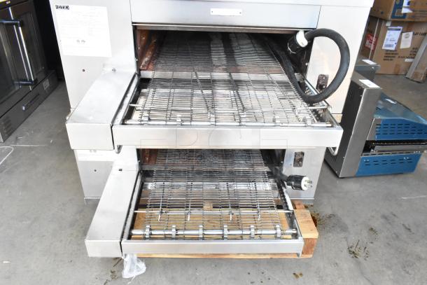 Middleby Marshall DZ33T stainless steel conveyor pizza ovens, 2022 model, electric, on commercial casters, 208V, shown in a warehouse.