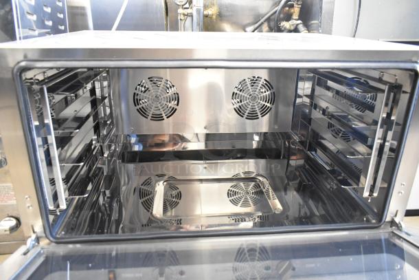 Brand new KoolMore KM-CTCO-44 stainless steel convection oven, interior view, with visible fans and shelves, scratch and dent condition.