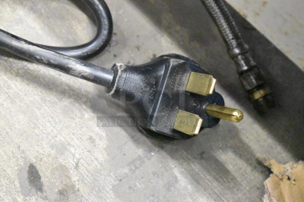 Black power plug for a KoolMore KM-CTCO-44 convection oven, showing metal prongs and electrical markings.