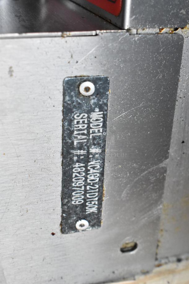 Vulcan VC4GD-21D150K convection oven label showing model and serial numbers on stainless steel surface.