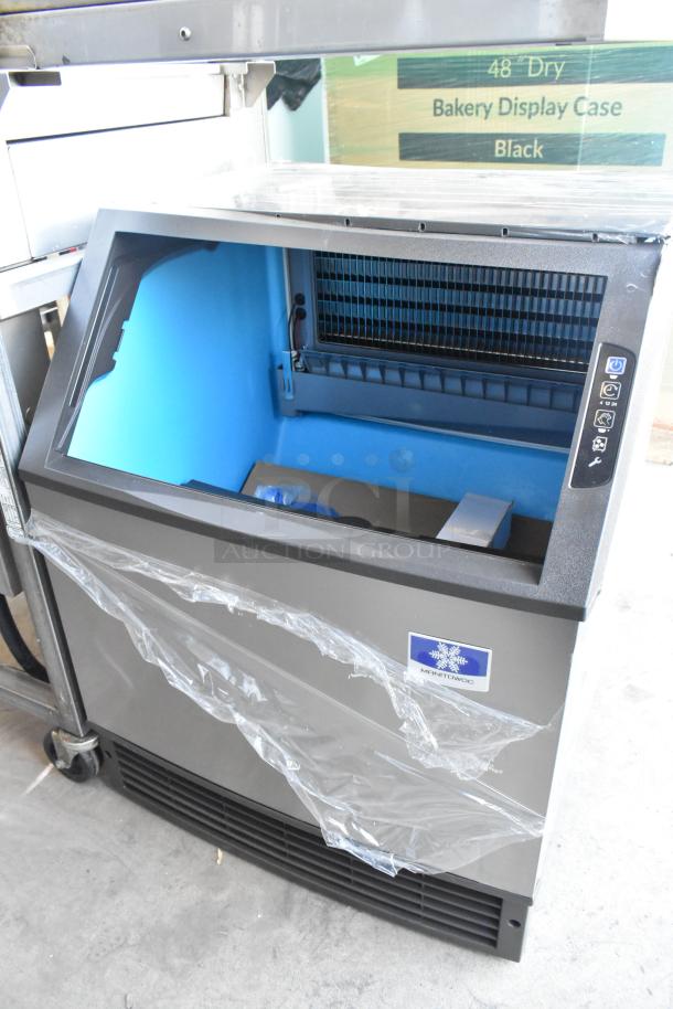 2024 Manitowoc UYF0190A-161B stainless steel ice machine, 90 lb. bin, new condition, minor dents. 200 lb. capacity.