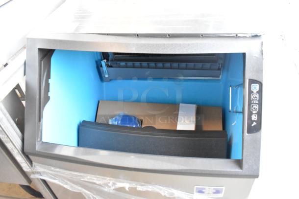 Brand new Manitowoc UYF0190A-161B undercounter ice machine, stainless steel, 90 lb. bin, visible interior and control panel.