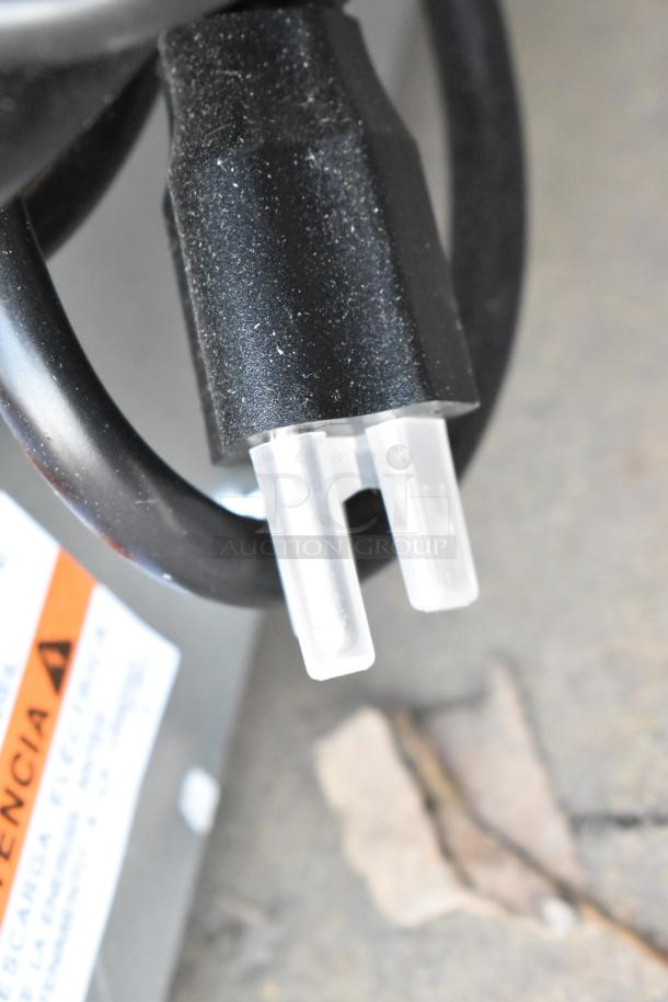Close-up of a power plug for a Manitowoc UYF0190A-161B ice machine, showing a plastic connector and part of a label.