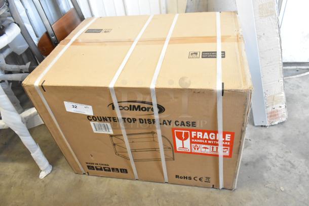 Boxed KoolMore DC-2C commercial bakery display case, new condition, 1.5 cu. ft., fragile label visible.