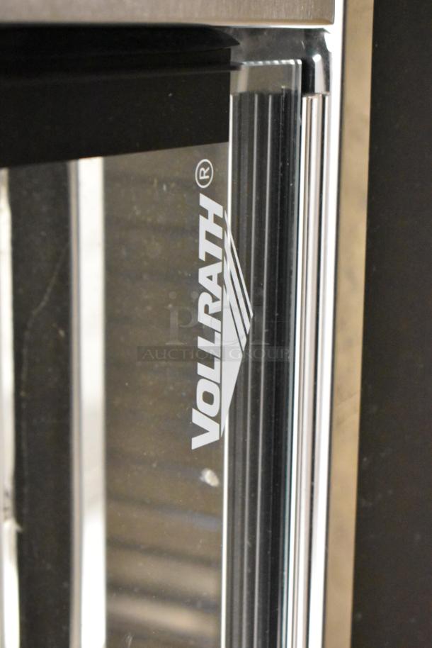 Brand new Vollrath FMA7026 26" Hot Food Merchandiser, 120V, 1 phase, minor scratches on glass, Vollrath logo visible.