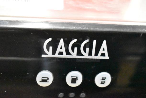 Brand new Gaggia CGG191D50NU Ruby Pro automatic espresso machine with buttons shown. Includes portafilter and steam wand.