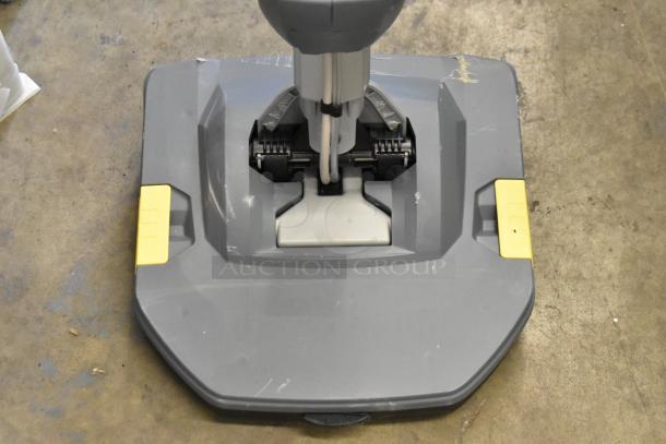 Brand new scratch and dent 2021 Karcher BR 30/1 C BP 12" cordless floor scrubber, visible wear on the surface, includes lithium-ion battery and charger.