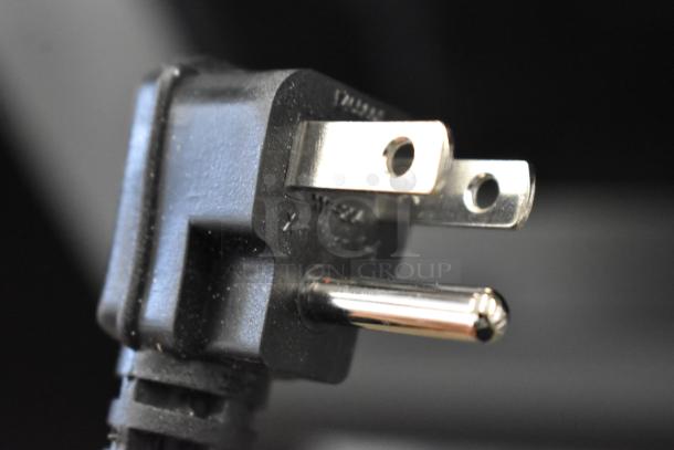 Close-up of a power plug for the KoolMore KM-PHR-45C pharmacy refrigerator, showing a three-prong design.