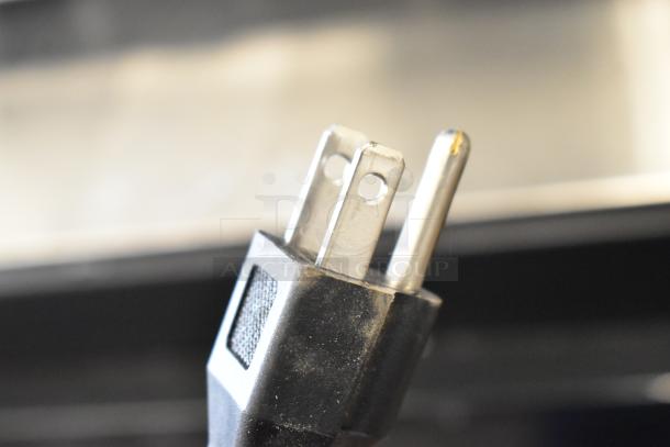Close-up of a power plug for the 2024 Avantco 178UBB72SGT back bar refrigerator. Features a three-prong design.