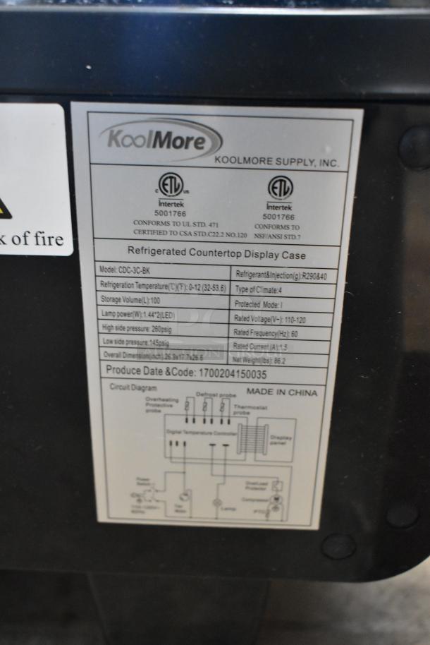Label on KoolMore CDC-3C-BK refrigerated display case showing model details, voltage, dimensions, and manufacturing info.