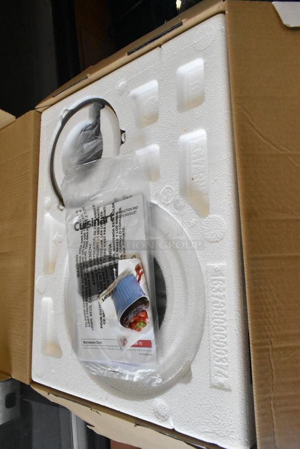 Brand new Cuisinart CMW-70WH Compact Microwave Oven in open packaging. Visible instruction manual and accessories. 120 Volts, 1 Phase.