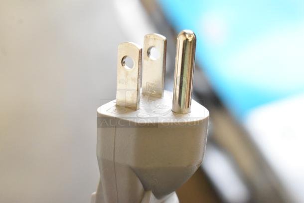 Close-up of a three-prong plug attached to a Cuisinart CMW-70WH Compact Microwave Oven, featuring 120 volts, 1 phase.