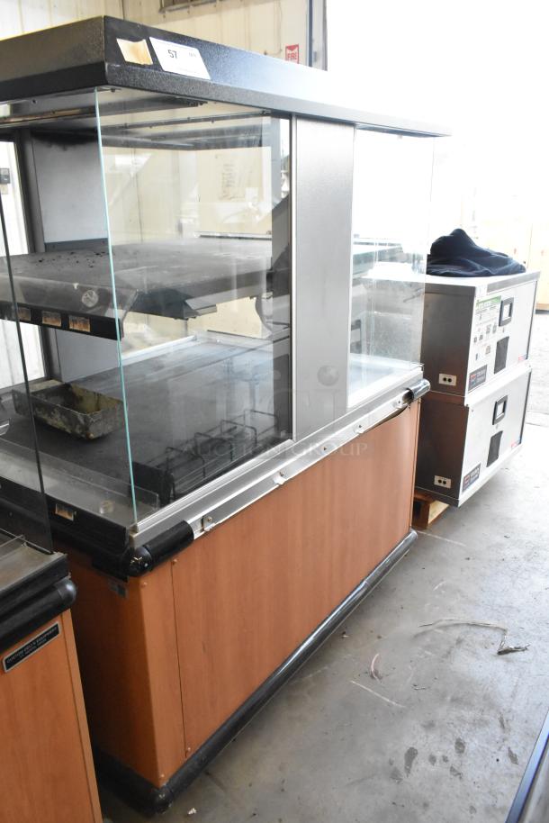 Custom Deli's Inc metal 2-tier warming display case on casters, 120-208 volts, 1 phase, glass panels, wood accents, used condition.