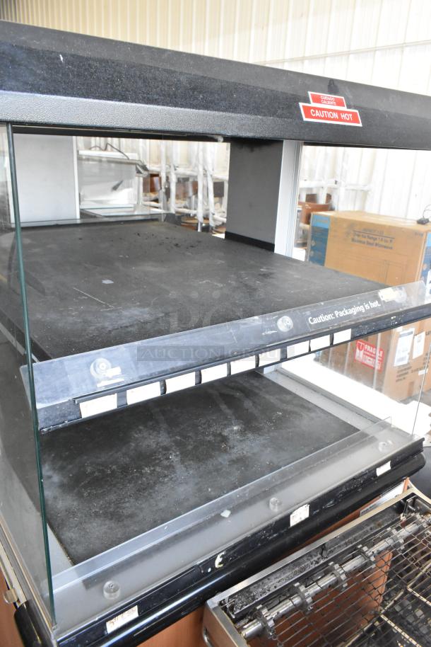 Custom Deli's Inc 2-Tier Metal Warming Display Case on Casters. 120-208V, 1 Phase. Visible "Caution Hot" label.