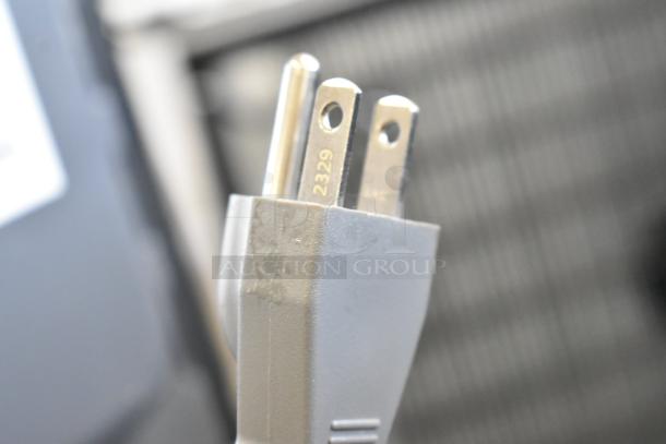 Close-up of a plug for the Hamilton Beach HB4302797514-01 Countertop Microwave Oven; 120 Volts, 1 Phase.