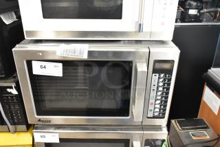 2017 Amana RCS10TS stainless steel commercial countertop microwave, 120V. Features keypad, minor surface wear, auction tag visible.