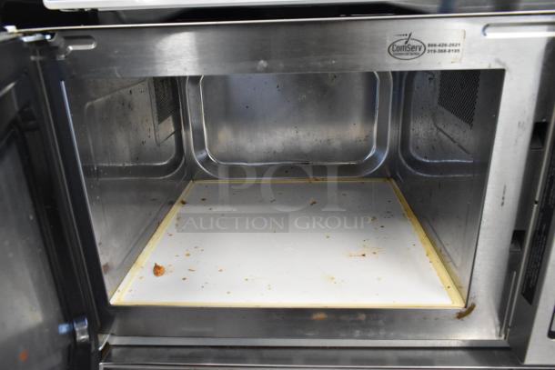 2017 Amana RCS10TS stainless steel commercial microwave, 120 volts, visible wear, ComServ label inside.