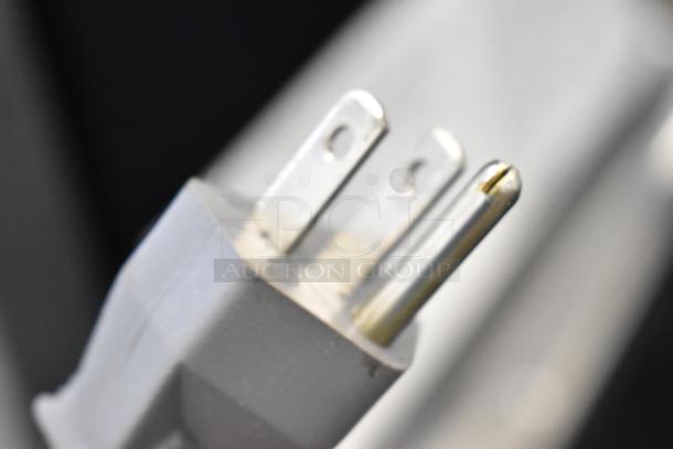 Close-up image of a power plug. This appears to be part of the Amana RCS10TS commercial microwave.