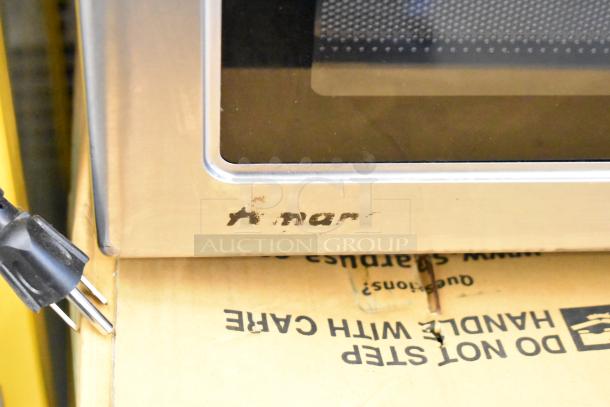Amana RCS10TS stainless steel commercial microwave oven, slightly worn exterior, 120 volts, visible logo wear.