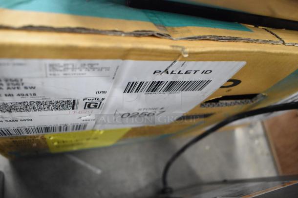 Original box for Sharp R-21LVF Countertop Microwave, 120 Volts, 1 Phase, visible shipping labels and pallet ID.