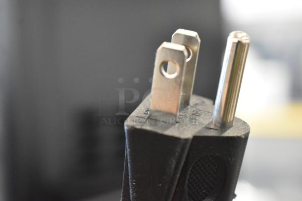 Close-up image of a power plug for the Hamilton Beach HB8436127995-01 stainless steel commercial countertop microwave oven.