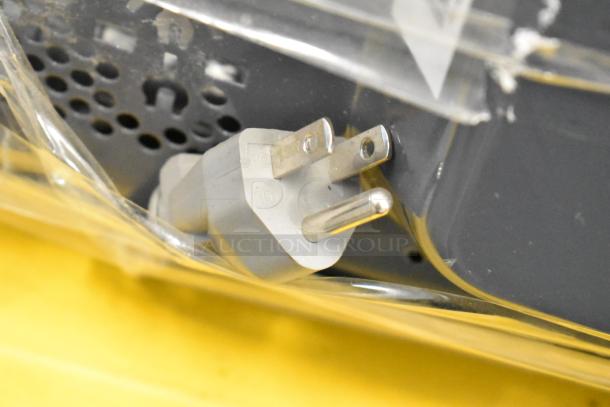 Close-up of a power plug on the 2023 Hamilton Beach HB4302797514-01 Stainless Steel Commercial Microwave Oven.