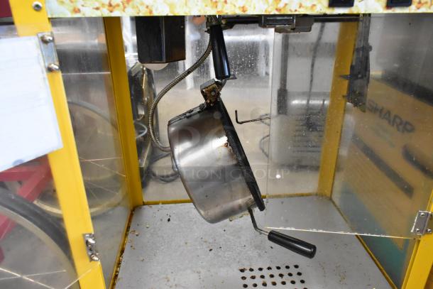 Metal commercial countertop popcorn machine, 115 Volts, 1 Phase. Stainless steel pot with black handle. Visible wear.