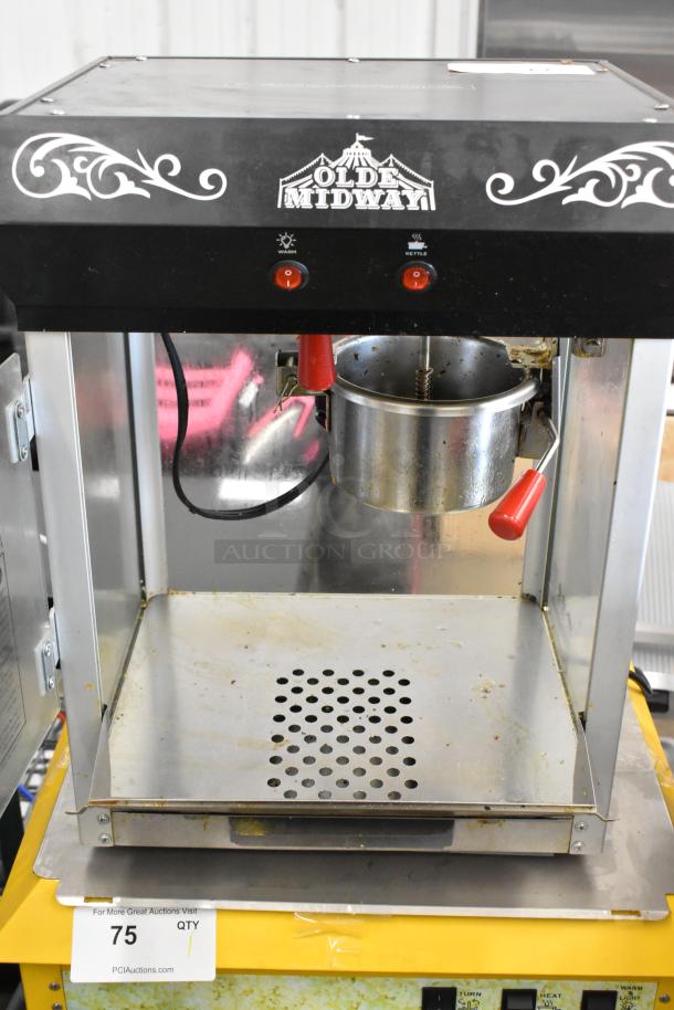 Olde Midway P600 Metal Popcorn Machine, black top with logo, red switches, stainless interior, 120V, 1 Phase, used condition.