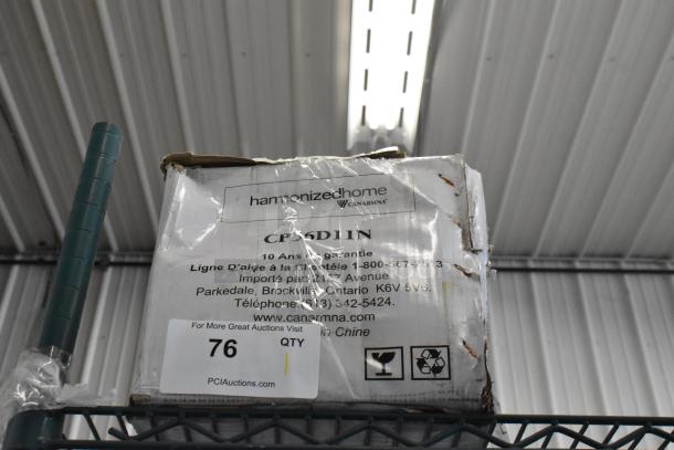 BRAND NEW Canarm CP56D11N 56" Industrial Ceiling Fan, box dented. Harmonized Home label visible, includes warranty info.