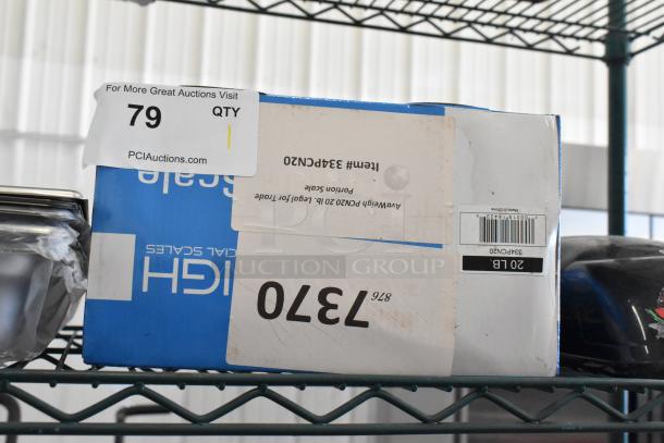 Brand new AvaWeigh 334PCN20 20 lb. portion scale, legal for trade, in original box with visible scratches and dents.