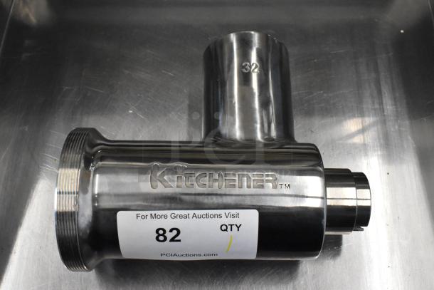 Brand new Kitchener 32 stainless steel meat grinder attachment, minor dents, visible brand logo, item tag with lot number 82.