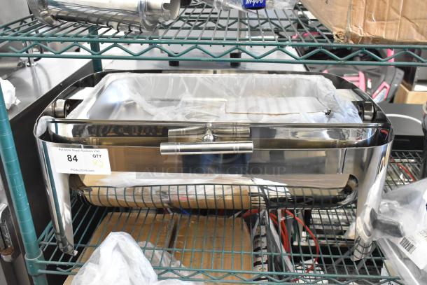 Brand new stainless steel roll top chafing dish with minor scratches and dents. Includes retail label showing "84 QTY." Perfect for catering use.