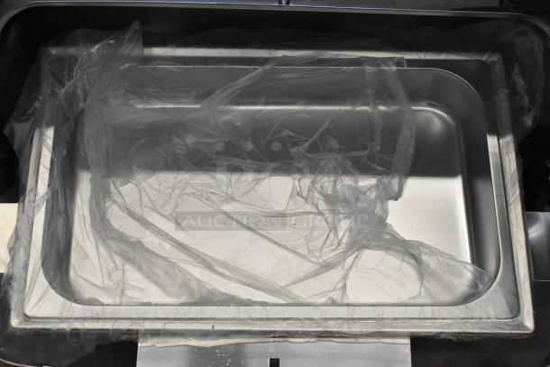 Brand new stainless steel roll top chafing dish, slight scratches, still in protective wrapping. Ideal for catering.