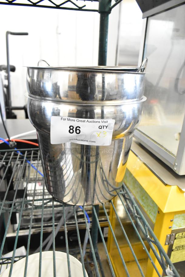 Brand new stainless steel drop-in bin with label indicating auction lot 86, quantity 3, on a metal shelf.