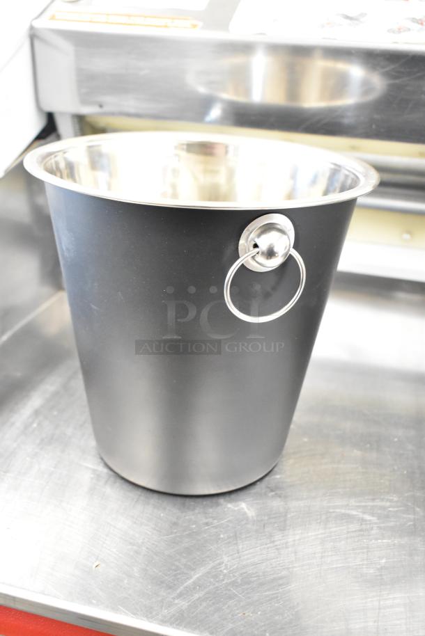 Metal ice bucket with stainless steel rim and handle. Brand new, in pristine condition. Part of a 3-piece auction set.