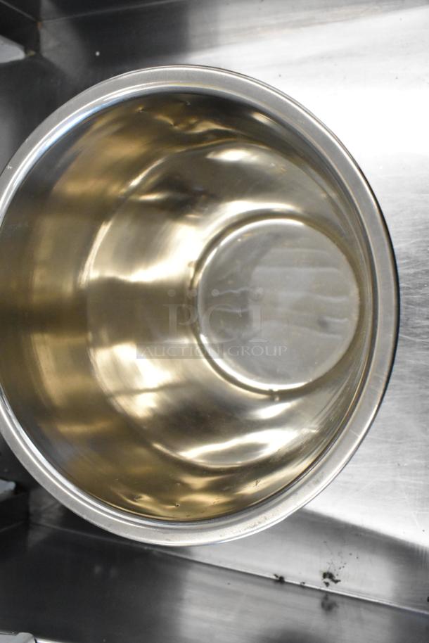 Stainless steel cylindrical drop-in bin, brand new with slight imperfections, reflective finish. Part of auction lot.