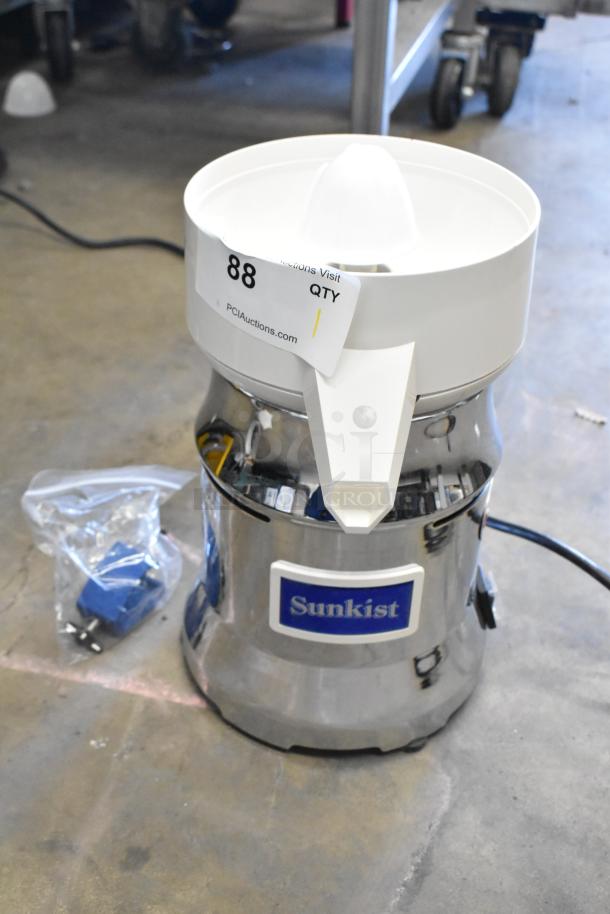 Brand new Sunkist 8-R metal citrus juicer, scratch and dent condition, 115 volts, 1 phase, with visible manufacturer's tag.