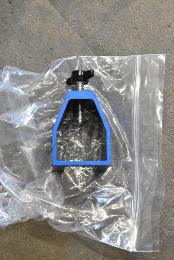 Blue metal clamp component in a plastic bag, unused condition, related to Sunkist 8-R Citrus Juicer.
