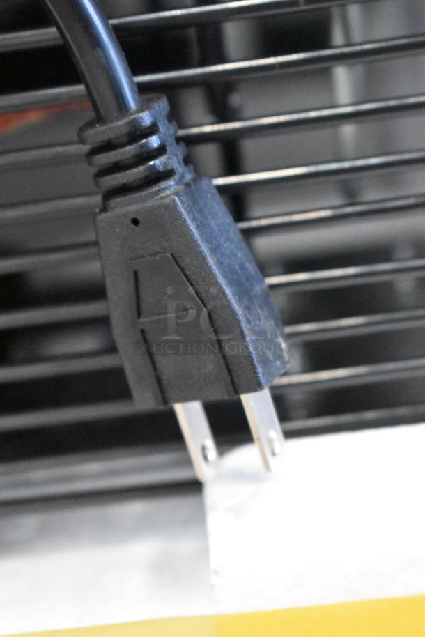 Close-up of the plug for a KoolMore KM-MDR-1D-6C metal commercial cooler merchandiser.